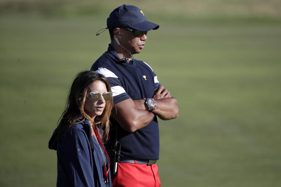 Tiger Woods, top, assistant United States team captain, and his associate Erica Herman, watch play on the 17th hole during the final round of the Presidents Cup golf tournament at Liberty National Golf Club in Jersey City, N.J., Sunday, Oct. 1, 2017. (AP Photo/Julio Cortez)