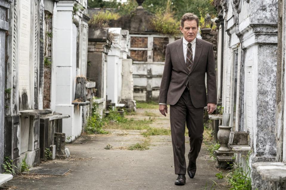 Bryan Cranston, in suit and tie, walks among headstones in a scene from "Your Honor."