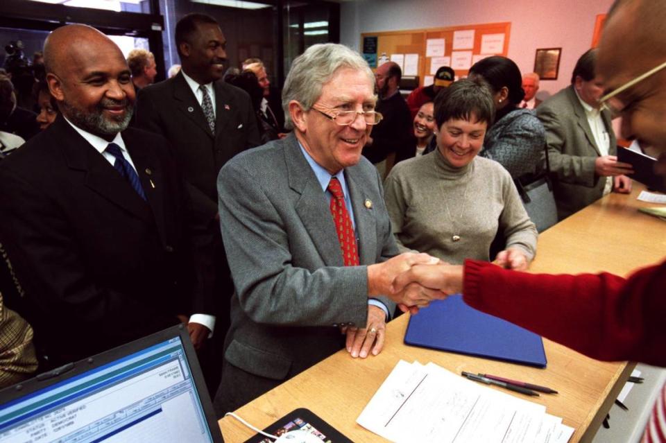 State Sen. Fountain Odom, middle, shakes Tony Jordan’s hand after filing with the Mecklenburg County Board of Elections. File photo. WENDY YANG