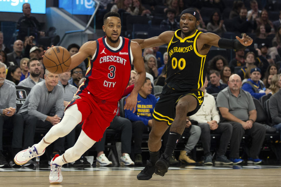 New Orleans Pelicans guard CJ McCollum (3) drives past Golden State Warriors forward Jonathan Kuminga (00) during the first quarter of an NBA basketball game, Wednesday, Jan. 10, 2024, in San Francisco. (AP Photo/D. Ross Cameron)