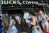 Starbucks workers attend a protest as part of a collective action over a Pride decor dispute, outside a Starbucks shop