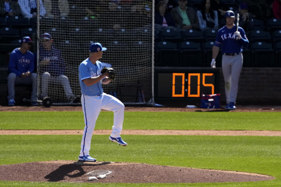 Kansas City Royals Nick Wittgren throws before a pitch clock runs down during the fifth inning of a spring training baseball game against the Texas Rangers Friday, Feb. 24, 2024, in Surprise, Ariz. (AP Photo/Charlie Riedel)