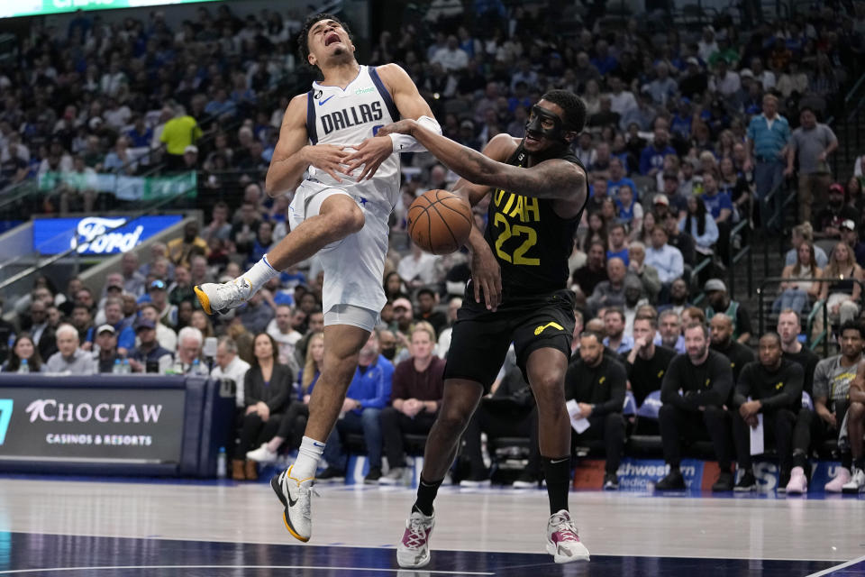 Dallas Mavericks guard Josh Green (8) is stripped of the ball driving to the basket b y Utah Jazz's Rudy Gay (22) in the first half of an NBA basketball game, Tuesday, March 7, 2023, in Dallas. (AP Photo/Tony Gutierrez)