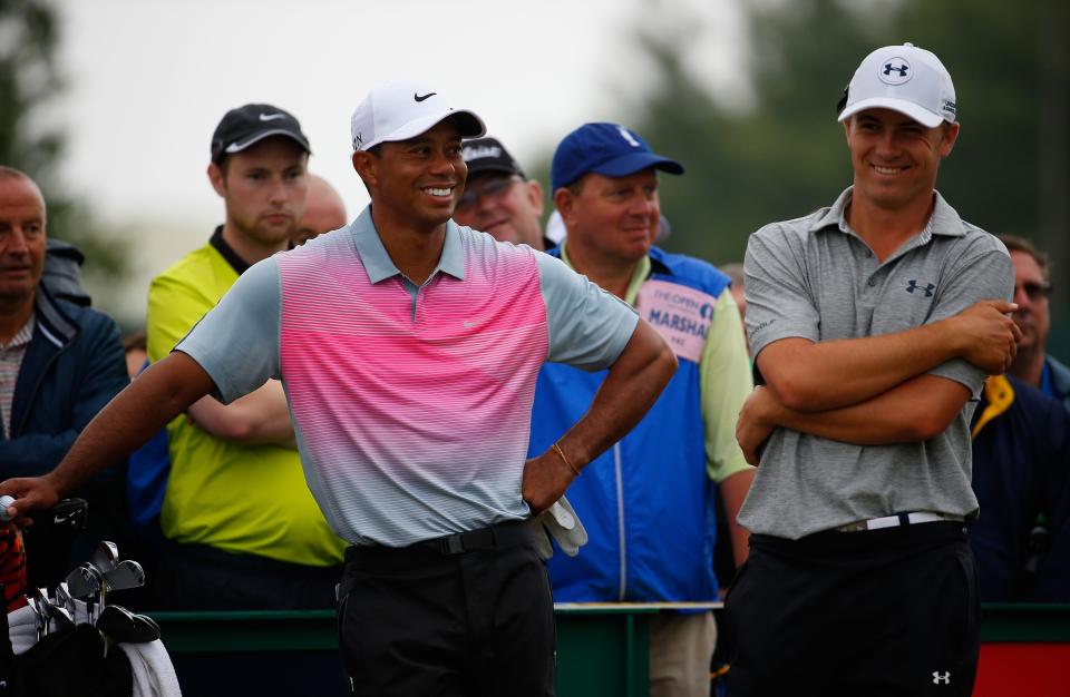 HOYLAKE, ENGLAND - JULY 19: Tiger Woods of the United States shares a joke with Jordan Spieth of the United States (R) during the third round of The 143rd Open Championship at Royal Liverpool on July 19, 2014 in Hoylake, England. (Photo by Tom Pennington/Getty Images)