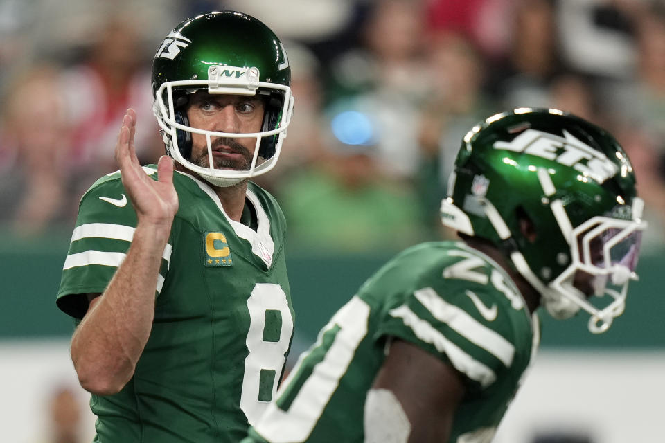 New York Jets quarterback Aaron Rodgers (8) motions on the line of scrimmage against the New England Patriots during the first quarter of an NFL football game, Thursday, Sept. 19, 2024, in East Rutherford, N.J. (AP Photo/Seth Wenig)