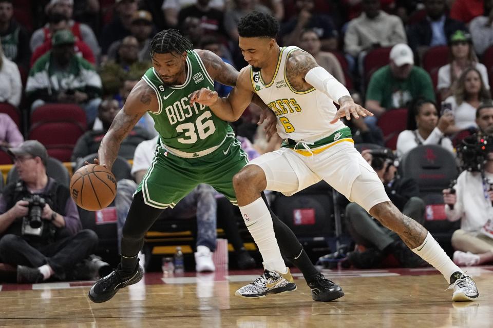 Boston Celtics' Marcus Smart (36) steals the ball from Houston Rockets' KJ Martin Jr. (6) during the first half of an NBA basketball game Monday, March 13, 2023, in Houston. (AP Photo/David J. Phillip)