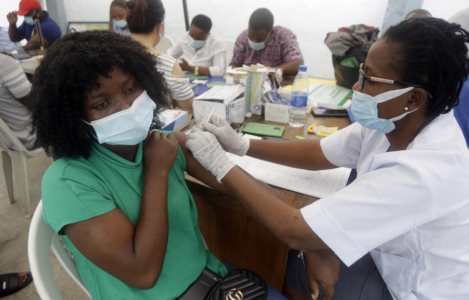 A woman receives her second coronavirus vaccination, the Moderna vaccine, at the health center in Lagos, Nigeria Wednesday, Aug. 25, 2021. Nigeria has begun the second rollout of COVID-19 vaccines as it aims to protect its population of more than 200 million amid an infection surge in a third wave of the pandemic. (AP Photo/Sunday Alamba)