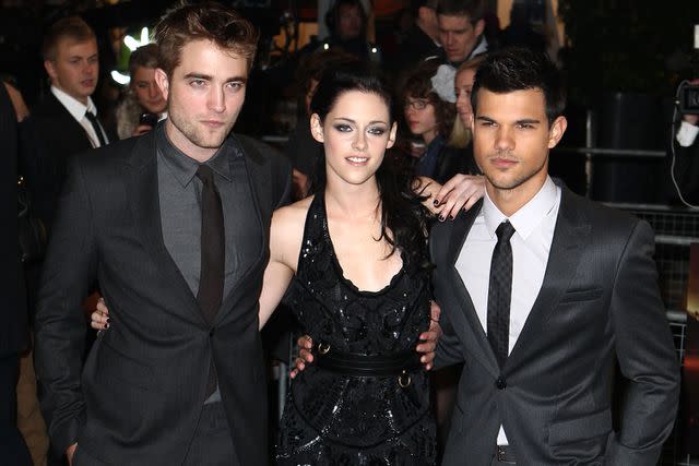 <p>Fred Duval/FilmMagic</p> Robert Pattinson, Kristen Stewart and Taylor Lautner in London on Nov. 16, 2011