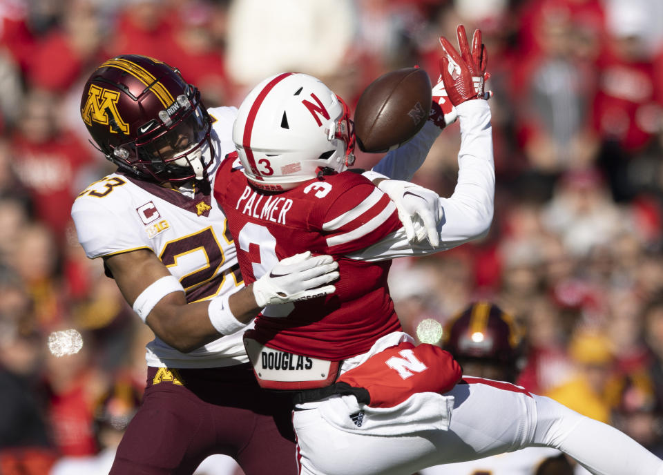 Nebraska's Trey Palmer (3) reaches for a pass as Minnesota's Jordan Howden (23) defends during the first half of an NCAA college football game Saturday, Nov. 5, 2022, in Lincoln, Neb. (AP Photo/Rebecca S. Gratz)