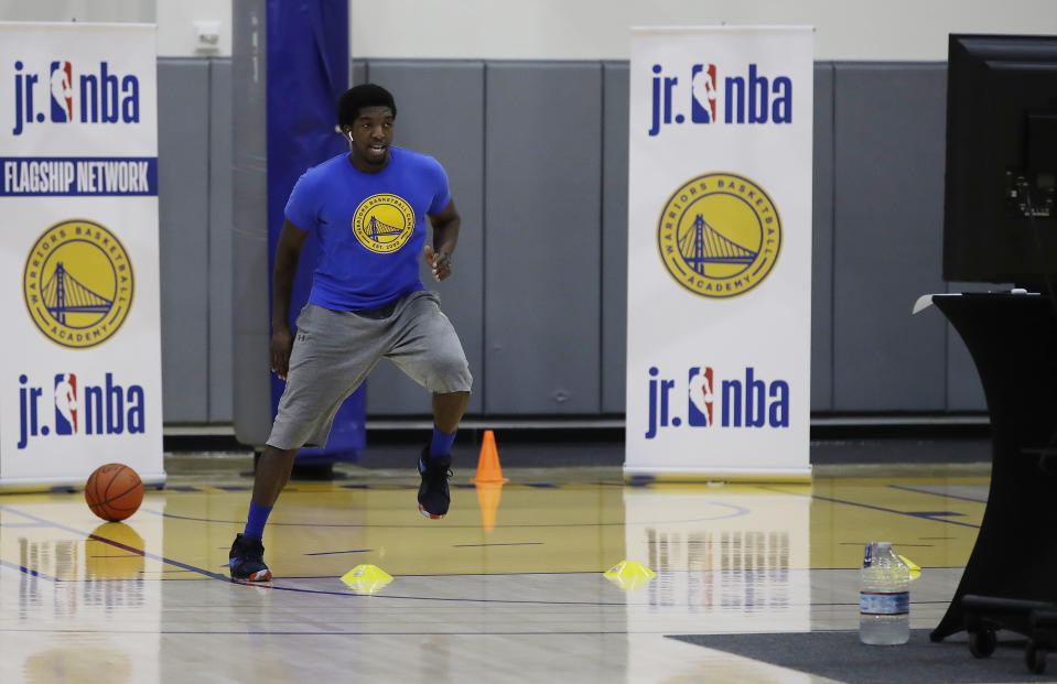 In this photo taken on Tuesday, June 9, 2020, Aalim Moor performs a drill for virtual students at Golden State Warriors basketball camp in Oakland, Calif. The State had to adapt their popular youth basketball camps and make them virtual given the COVID-19 pandemic. (AP Photo/Ben Margot)