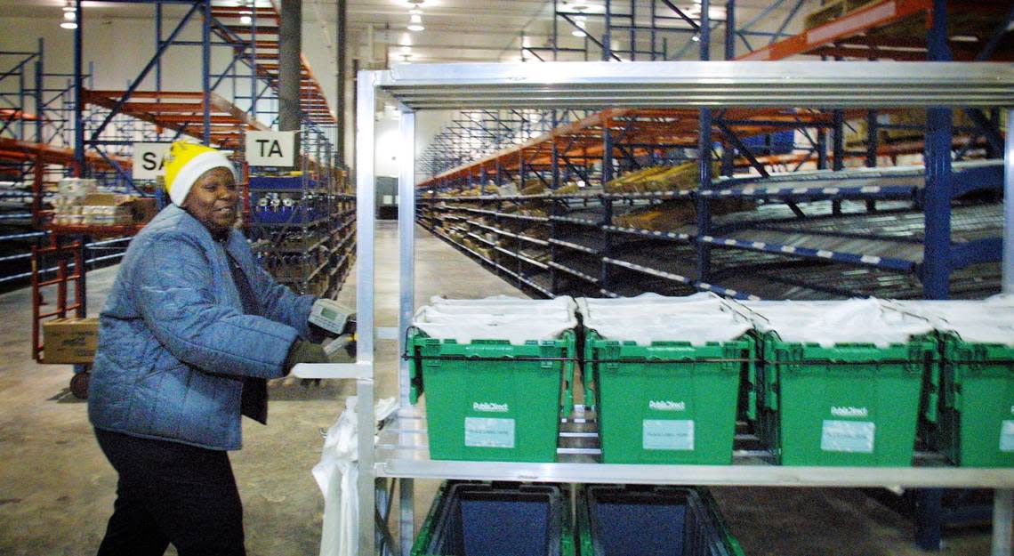 Sheila Etienne shops for customers at the PublixDirect warehouse.