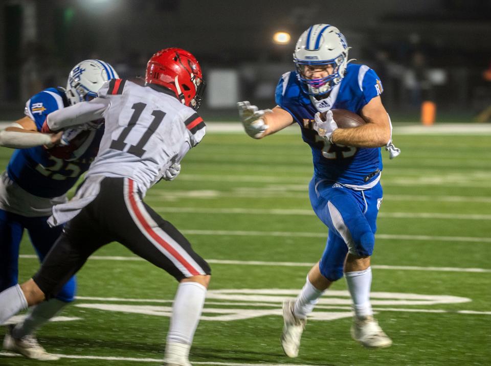 Ripon Christian's Grant Sonke, right, evades Woodland Christian's Carter Lang during the CIF Sac-Joaquin Section Division VII football championship at St. Mary's High School in Stockton on Friday, Nov. 25, 2022. 