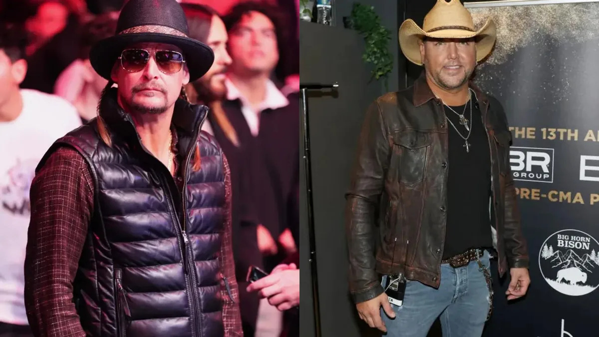 Two white men are pictured. On the left, he wears a black vest jacket over a red flannel and black fedora. The man on the right side wears a black leather jacket over a black shirt and blue jeans. 