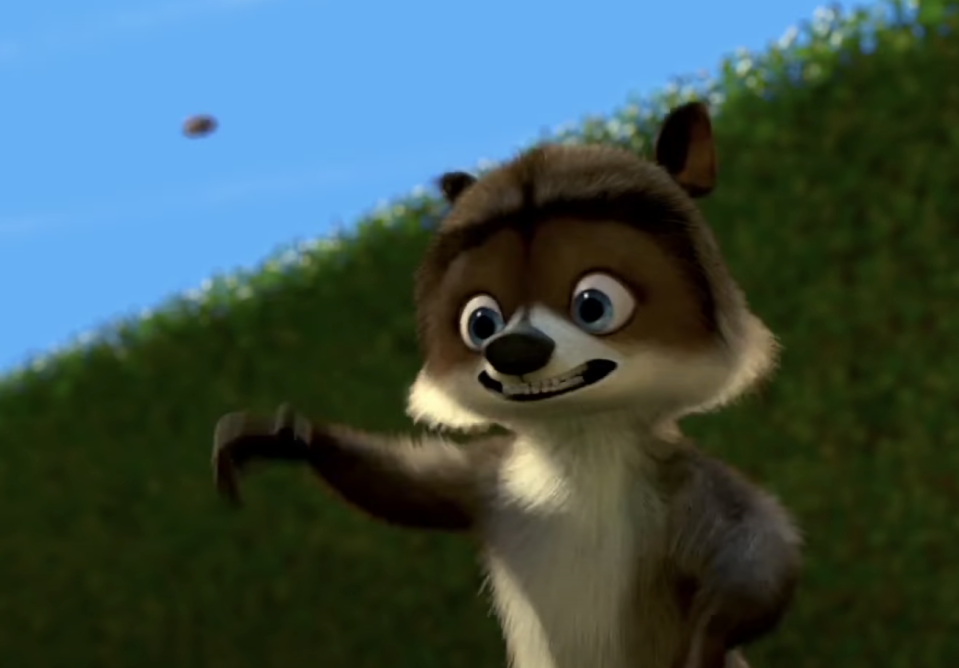 Animated character RJ from "Over the Hedge" looks at an object in the sky with his paw outstretched