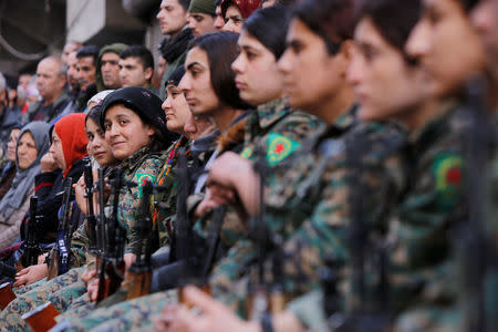 Kurdish female fighters of the Women's Protection Unit (YPJ) sit together in the Sheikh Maksoud neighbourhood of Aleppo, Syria February 7, 2018. REUTERS/Omar Sanadiki