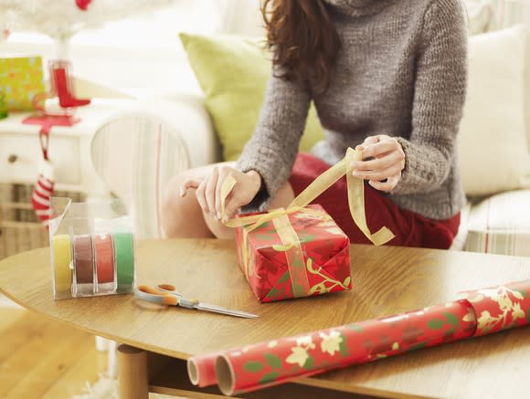 Woman wrapping presents.