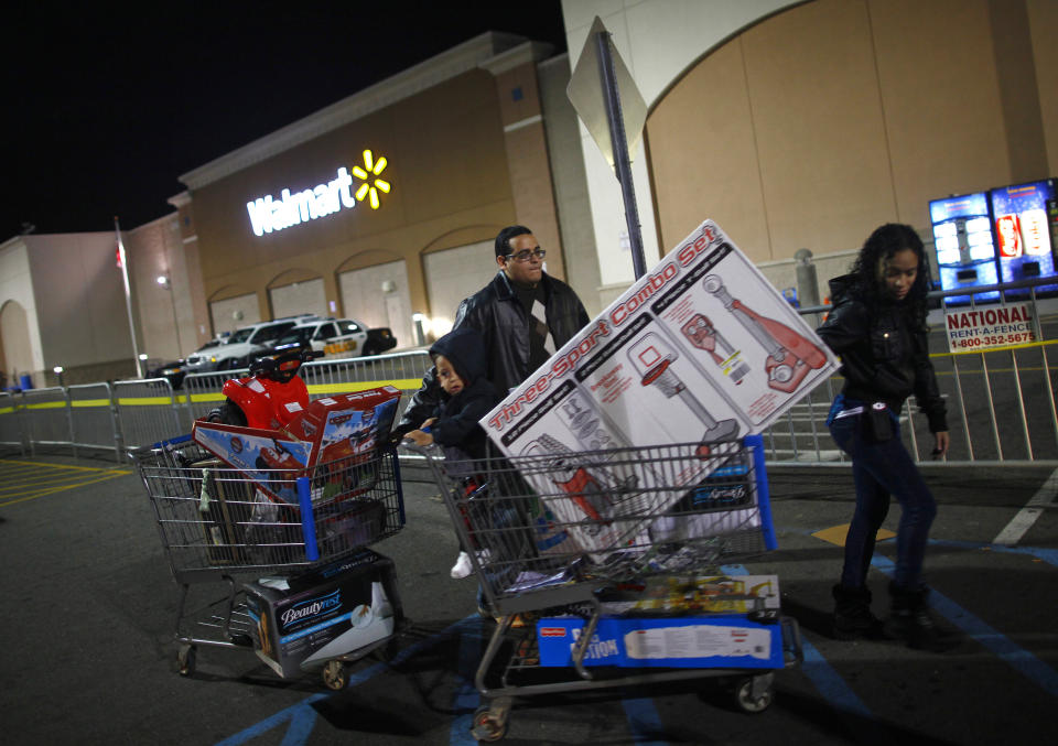 People pull loaded shopping carts at a Walmart store, on Thanksgiving day in North Bergen, New Jersey on November 22, 2012. REUTERS/Eric Thayer 