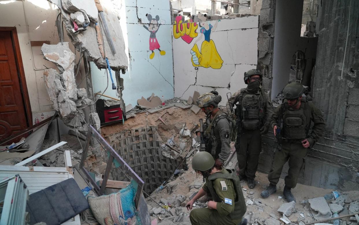 IDF soldiers inspect the entrance of a reported tunnel in Gaza