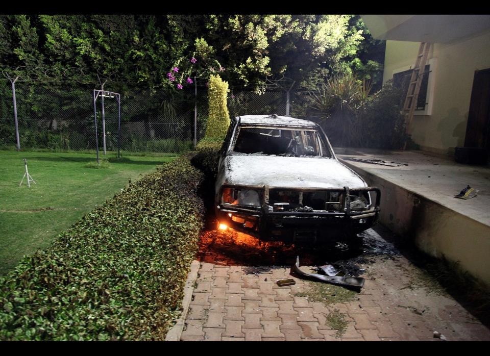 A burnt out vehicle sits smoldering in flames after it was set on fire inside the US consulate compound in Benghazi, late on September 11, 2012. (STR/AFP/GettyImages)