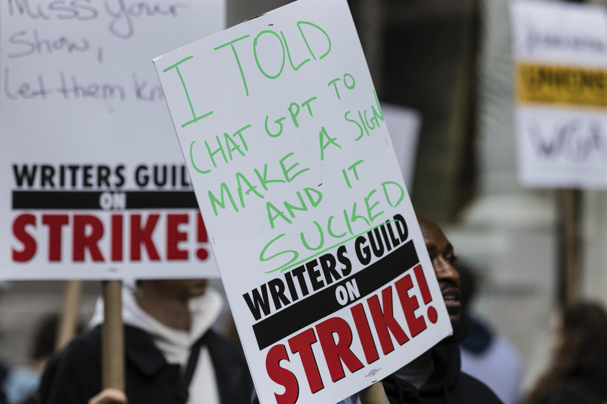 A person holds a sign that reads 'I told chat gpt to make a sign and it sucked' at a protest held by members of the Writers Guild of America union outside the Netflix headquarters near Union Square, Manhattan on Wednesday May 3, 2023, in New York. (AP Photo/Stefan Jeremiah)
