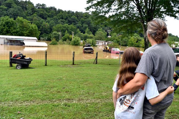 Bonnie Combs, right, hugs her 10-year-old granddaughter Adelynn Bowling watches as her property becomes covered by the North Fork of the Kentucky River in Jackson, Kentucky, on July 28. Flash flooding and mudslides were reported across the mountainous region of eastern Kentucky. (Photo: Timothy D. Easley/AP)