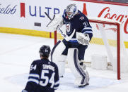Winnipeg Jets goaltender Connor Hellebuyck (37) celebrates the team's win over the Calgary Flames in an NHL hockey game Thursday, April 4, 2024, in Winnipeg, Manitoba. (John Woods/The Canadian Press via AP)