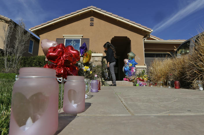 FILE - Neighbors write down messages for the Turpin's children on the front door of the home of David and Louise Turpin where police arrested the couple accused of holding 13 children captive in Perris, Calif., Wednesday, Jan. 24, 2018. Officials are investigating allegations that the county where the Southern California couple starved and shackled 12 of their 13 children failed to provide the basic services they needed to start a new life. ABC News reported Friday, Nov. 19, 2021, that Riverside County has hired a private law firm to look into allegations that the adult and minor children haven't received many basic services. (AP Photo/Damian Dovarganes, File)