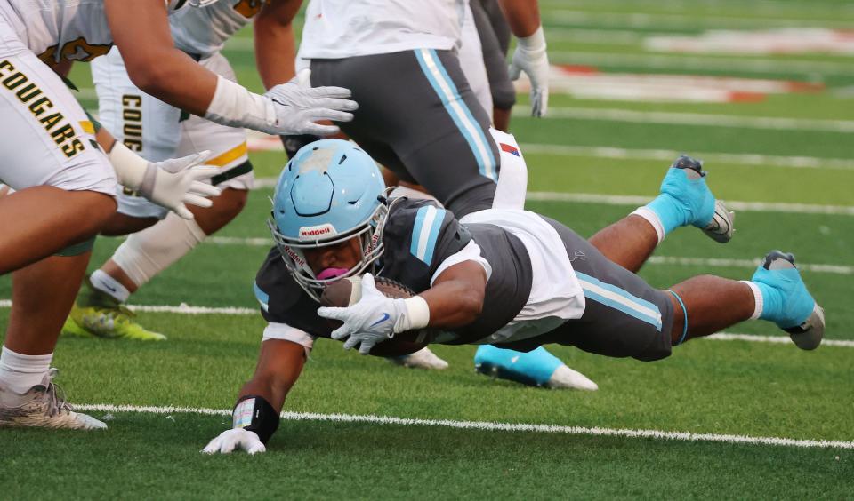 Granger’s Jordan Tuuao (9) dives for extra yardage against Kearns in West Valley City on Thursday, Sept. 21, 2023. | Jeffrey D. Allred, Deseret News