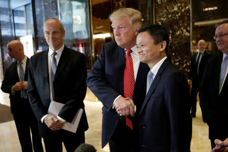 U.S. President-elect Donald Trump shakes hands with and Alibaba executive chairman Jack Ma after their meeting at Trump Tower in New York, U.S., January 9, 2017. REUTERS/Mike Segar