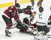Montreal goaltender Ann-Renee Desbiens, second from right, tries to stop the puck in front of the net just before Boston's Susanna Tapani, not seen, tipped it in during overtime in Game 1 of a PWHL hockey playoff series Thursday, May 9, 2024, in Montreal. (Christinne Muschi/The Canadian Press via AP)