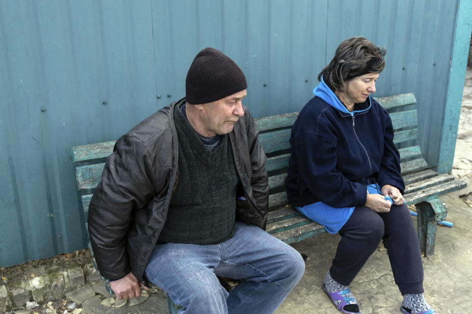 Valerii and Liubov Kozyr lost their daughter and son-in-law in the attack, along with their son-in-law's parents, who had been childhood friends of theirs, are sitting on the bench in the village of Hroza near Kharkiv, Ukraine, Friday, Oct. 6, 2023. Ukrainian officials say at least 51 civilians were killed as the Russian rocket hit a village store and cafe in one of the deadliest attacks in recent months. (AP Photo/Alex Babenko)