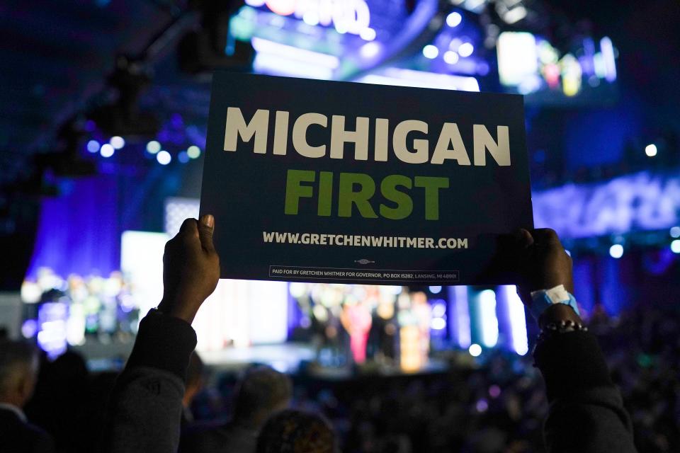 A person holds up a sign as Gov. Gretchen Whitmer speaks to a crowd while celebrating her reelection during the Michigan Democratic watch party for the midterm elections at the Motor City Casino Sound Board in Detroit in the early morning on Wednesday, Nov. 9, 2022.