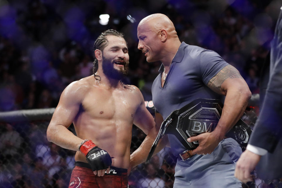 Jorge Masvidal, left, talks to Dwayne "The Rock" Johnson after a welterweight mixed martial arts bout against Nate Diaz at UFC 244 early Sunday, Nov. 3, 2019, in New York. Masvidal won in the fourth round.(AP Photo/Frank Franklin II)