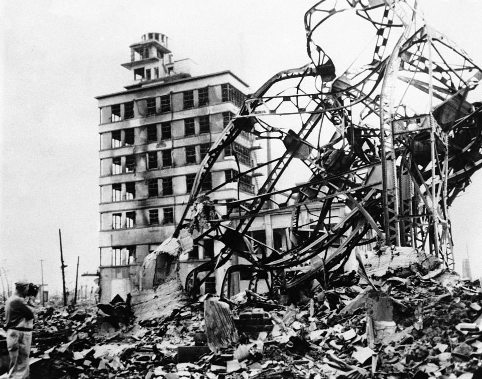 A twisted mass of steel, marks the site of a large building in the industrial centre of atomized Hiroshima, Japan, on Sept. 13, 1945, directly behind, in grim contrast, a partly demolished building towers up, amid acres of gutted and fire blackened debris.