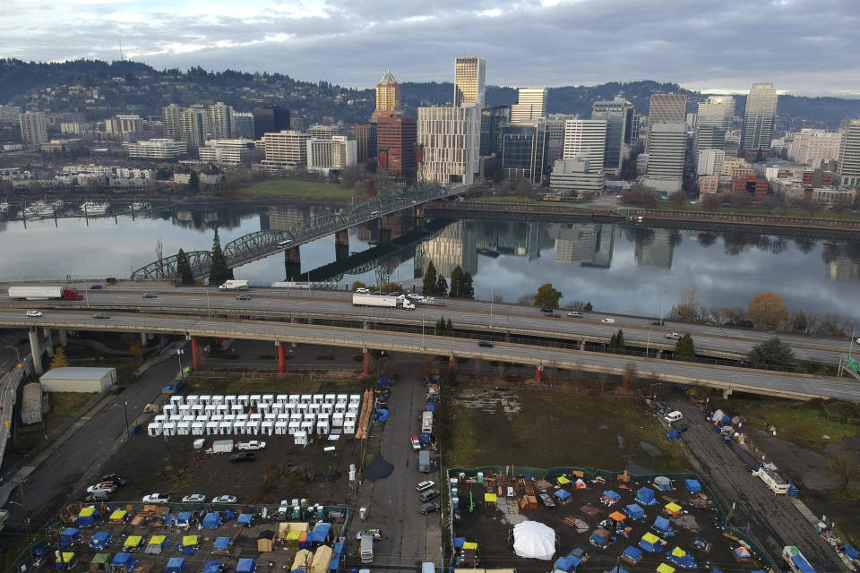 FILE - In this aerial photo tents housing people experiencing homelessness are set up on a vacant parking lot in Portland, Ore., on Dec. 8, 2020. A record 193 homeless people died in Oregon's Multnomah County, home to Portland, in 2021. A county report released Wednesday, Feb. 15, 2023, found that substances were involved in about 60% of the deaths. (AP Photo/Craig Mitchelldyer, File)