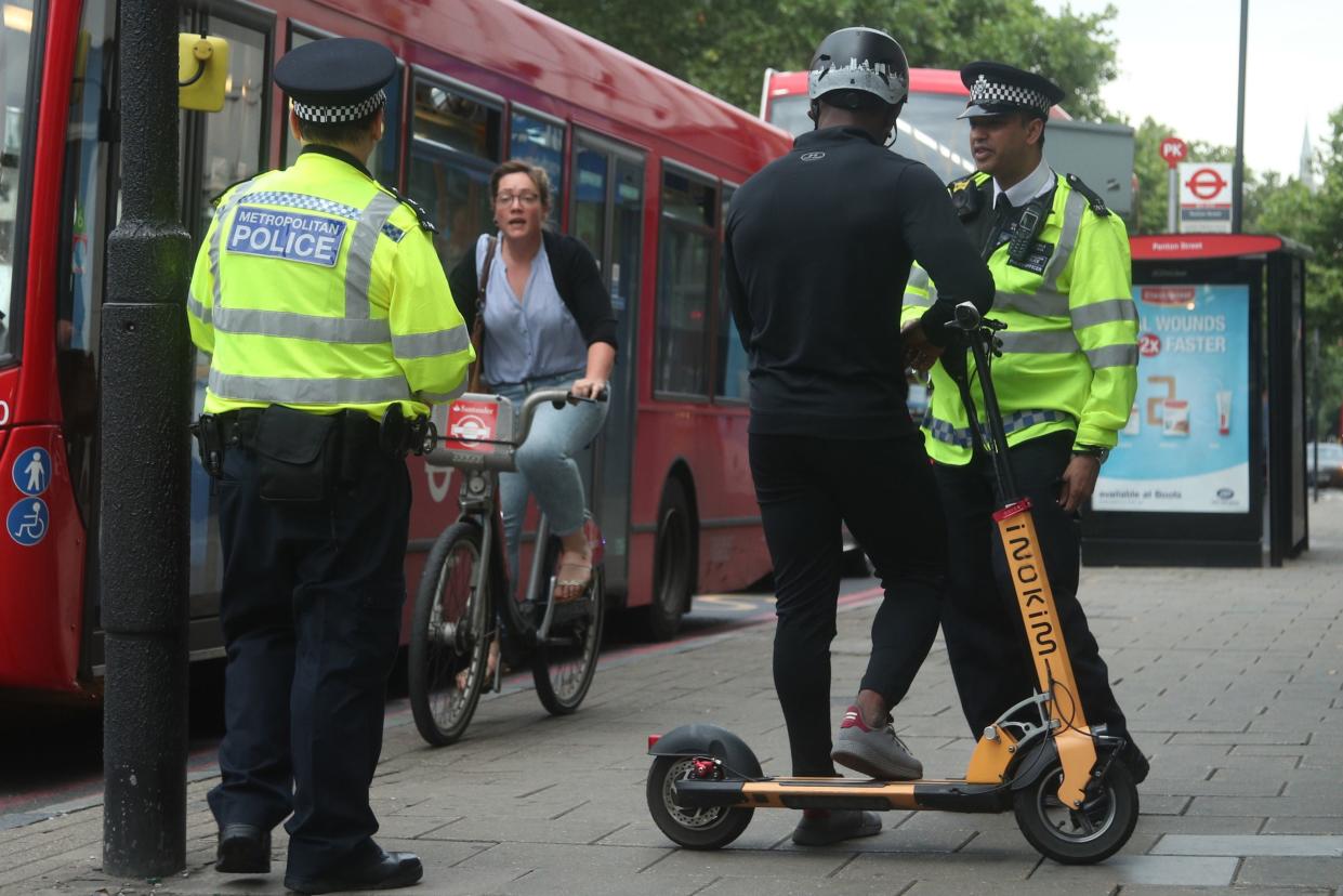 <p>Metropolitan Police officers in Islington talk to people riding e-scooters to educate them on the risks associated with the use of e-scooters</p> (PA)