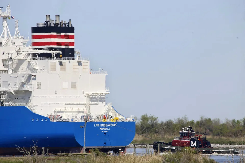 A tugboat helps guide the LNG Endeavor, a French liquefied natural gas tanker, through Calcasieu Lake near Hackberry, La., March 31, 2022. U.S. LNG exports to Europe reached record levels in 2022 as the continent prepared to sever energy ties with Russia. <a href=