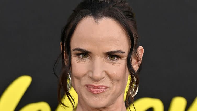 juliette lewis smiling for a photo at a premiere event red carpet