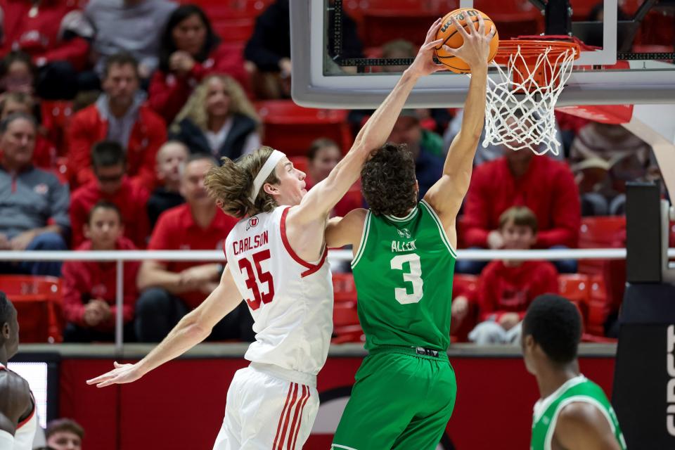 Utah Utes center Branden Carlson (35) meets Utah Valley Wolverines guard Drake Allen (3) at the hoop at the Huntsman Center in Salt Lake City on Saturday, Dec. 16, 2023. | Spenser Heaps, Deseret News