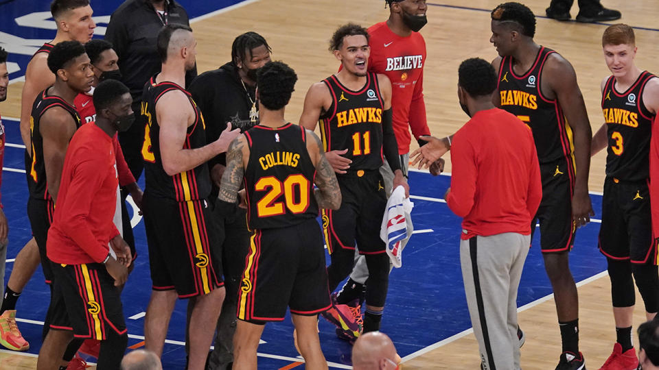 Trae Young and the Atlanta Hawks celebrate after scoring a 107-105 victory on the road against thew New York Knicks in their NBA playoff series. (Photo by Seth Wenig - Pool/Getty Images)