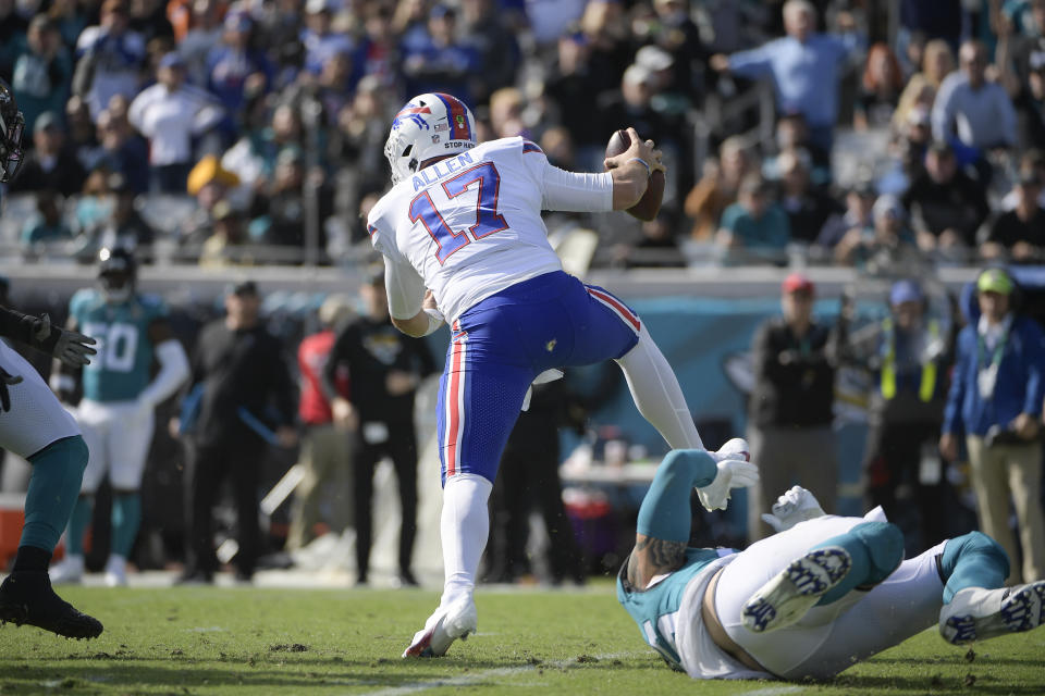 Buffalo Bills quarterback Josh Allen (17) avoids a tackle by Jacksonville Jaguars defensive end Adam Gotsis during the first half of an NFL football game, Sunday, Nov. 7, 2021, in Jacksonville, Fla. (AP Photo/Phelan M. Ebenhack)