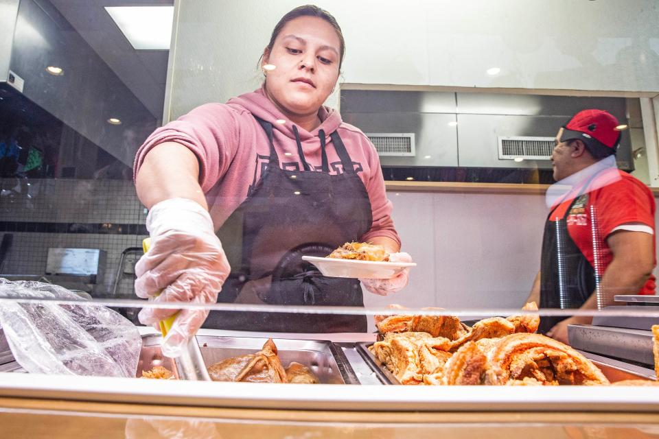Jhoanna Daniel Buendia, cook and tortilla maker, serves "carnitas" at Tortilleria Dos Milpas in Elsmere, Tuesday, Oct. 24, 2023. Dos Milpas makes tortillas from nixtamalized corn, with Michoacan-style carnitas, and is part of the reason why northern Delaware is deemed to have some of the best Mexican food in the region.