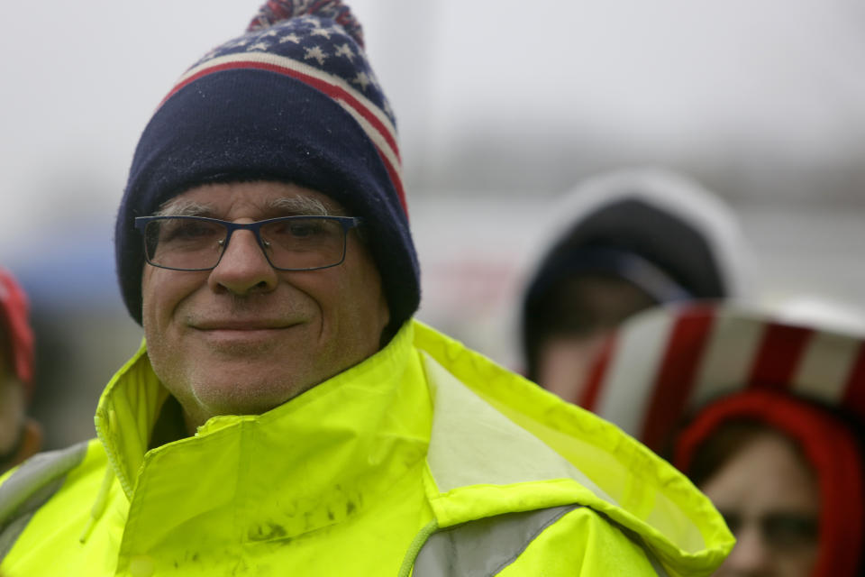 In this Oct. 26, 2020, photo, Robert Reed, stands in line to attend a campaign rally with President Donald Trump at Lancaster Airport in Lititz, Pa. Reed says he will always believe the 2020 election was stolen from President Donald Trump, the vote marred by “fraud.” Still, a day after the Electoral College made Joe Biden's win official, the ardent Trump supporter and retired police officer from the suburbs of Lancaster, Pennsylvania, was ready to move on. “I think it’s pretty much over,” Reed, 61, said Trump’s ongoing quest to overturn the election results. ”I trust the Electoral College.”(AP Photo/Jacqueline Larma)