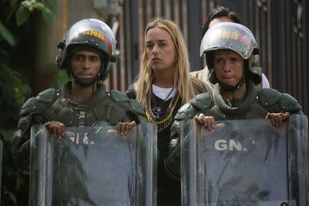 Venezuelan National Guards stand guard in front of Lilian Tintori (C), wife of jailed Venezuelan opposition leader Leopoldo Lopez, during a rally in support of political prisoners and against Venezuelan President Nicolas Maduro, outside the military prison of Ramo Verde, in Los Teques, Venezuela April 28, 2017. REUTERS/Marco Bello