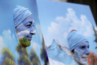 Susan Weis, left, Marci Ortega, and Paul Ortega, not pictured, are dressed as " Bob Ross and His Happy Paintings" on Mardi Gras day in New Orleans, Tuesday, Feb. 25, 2020. (AP Photo/Rusty Costanza)