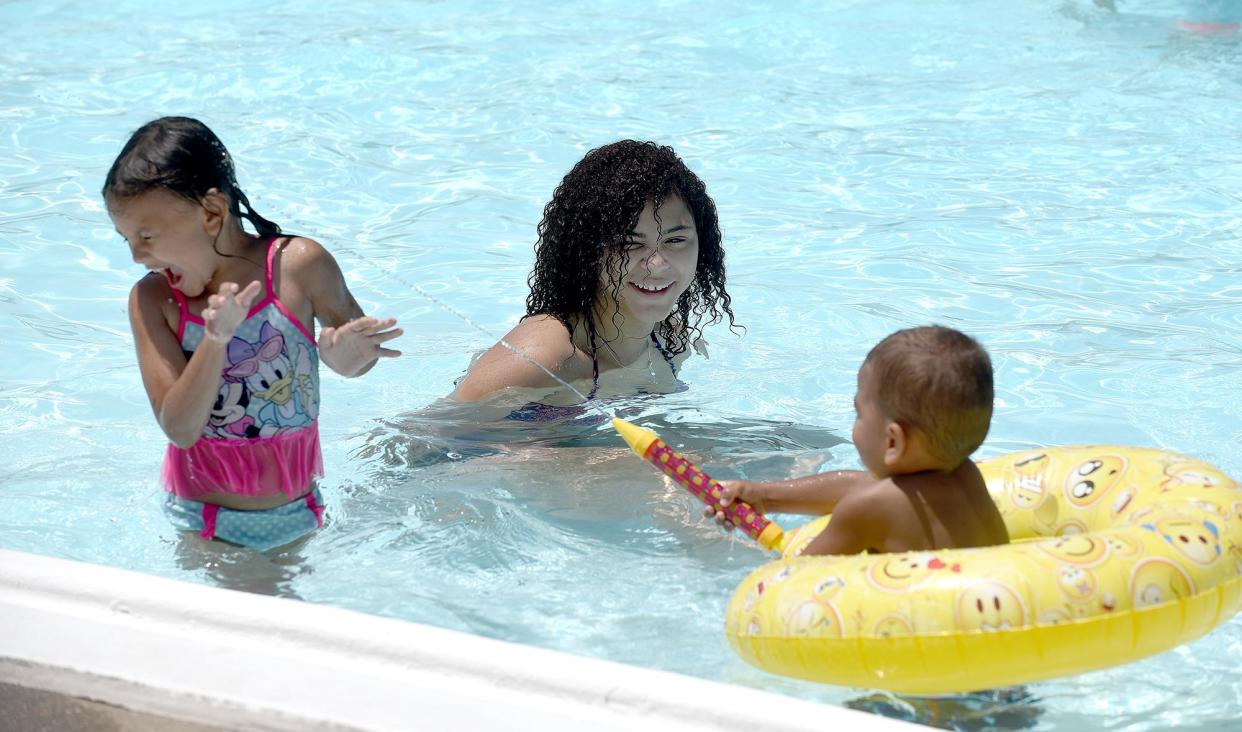 Darrien Davis plays with her niece Zylah Foote, 3, and her nephew Zayveon Colbert, 1, in 2019 at the Albert-Oakland Park Family Aquatic Center.