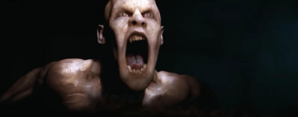 Gorr the God Butcher screams, shirtless, showing muscular frame and menacing expression in a dark setting, from the movie "Thor: Love and Thunder."