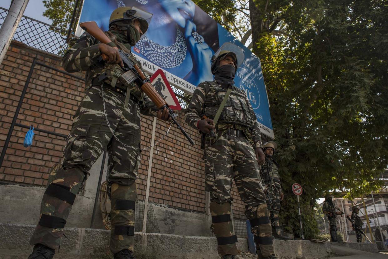 Indian government forces guard the deserted city centre during curfew-like restrictions: Getty