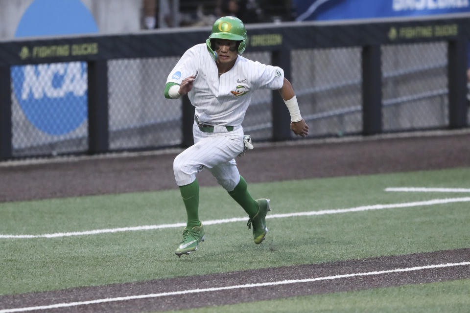 Oregon's Rikuu Nishida runs home off a walkoff single by Drew Cowley to win an NCAA college baseball tournament super regional game against Oral Roberts, Friday, June 9, 2023, in Eugene, Ore. (AP Photo/Amanda Loman)