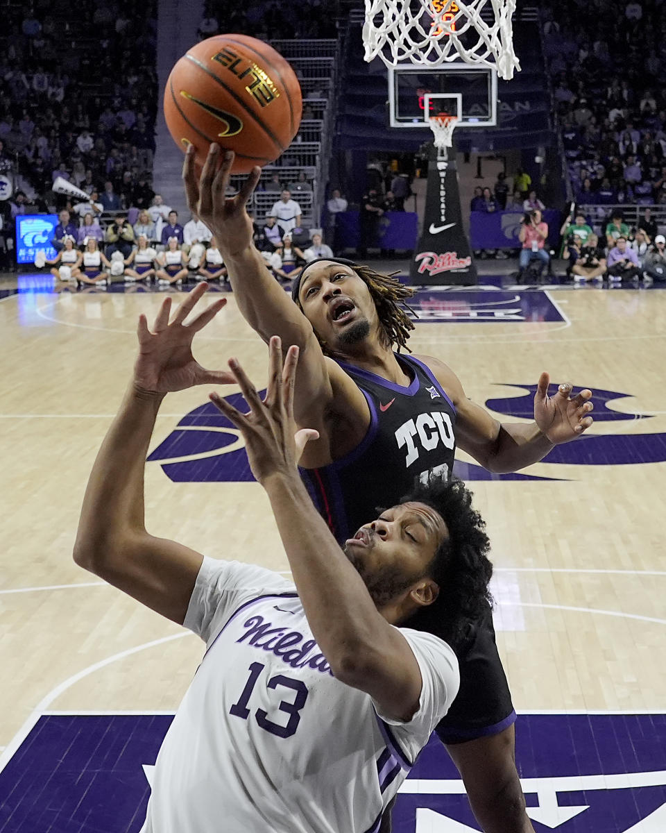 TCU forward Xavier Cork, back, beats Kansas State forward Will McNair Jr. (13) to a rebound during the first half of an NCAA college basketball game Saturday, Feb. 17, 2024, in Manhattan, Kan. (AP Photo/Charlie Riedel)